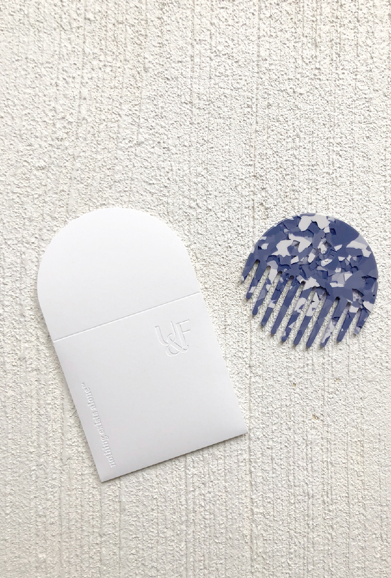 Plant cellulose comb in custom brand blue with FSC Certified paper pouch for United & Free